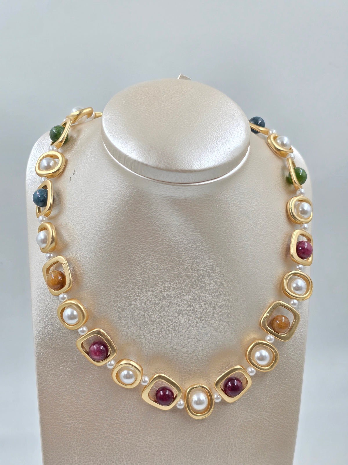 N - Necklace with gold, red, and white stones