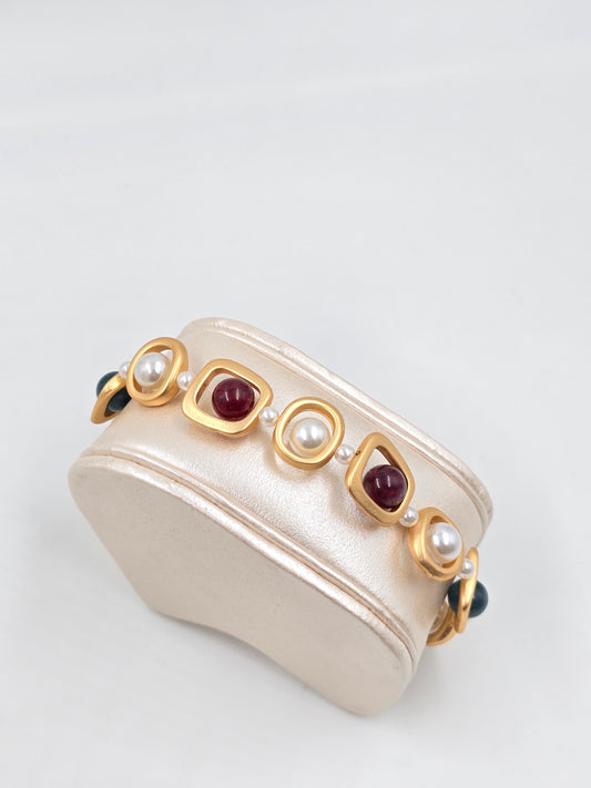 N - Necklace with gold, red, and white stones